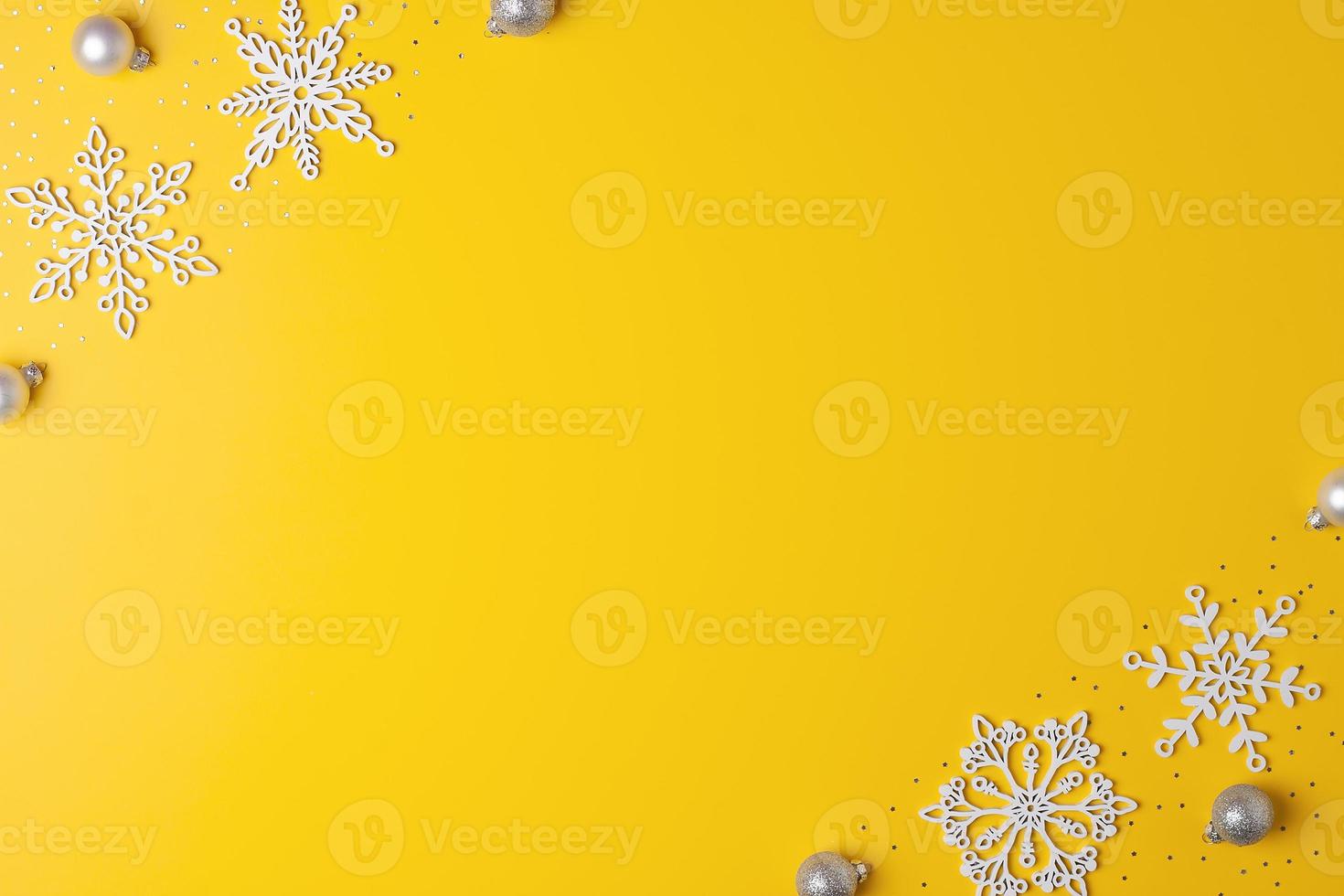 Christmas yellow minimal background with snowflakes. Flat lay, copy space photo