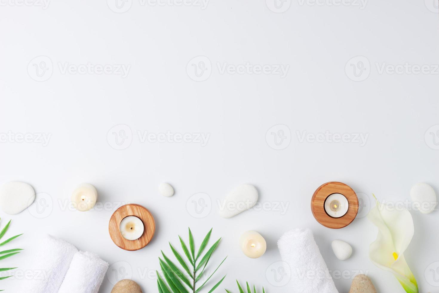 Spa treatment with towel, candles and palm on white background. Flat lay, copy space photo