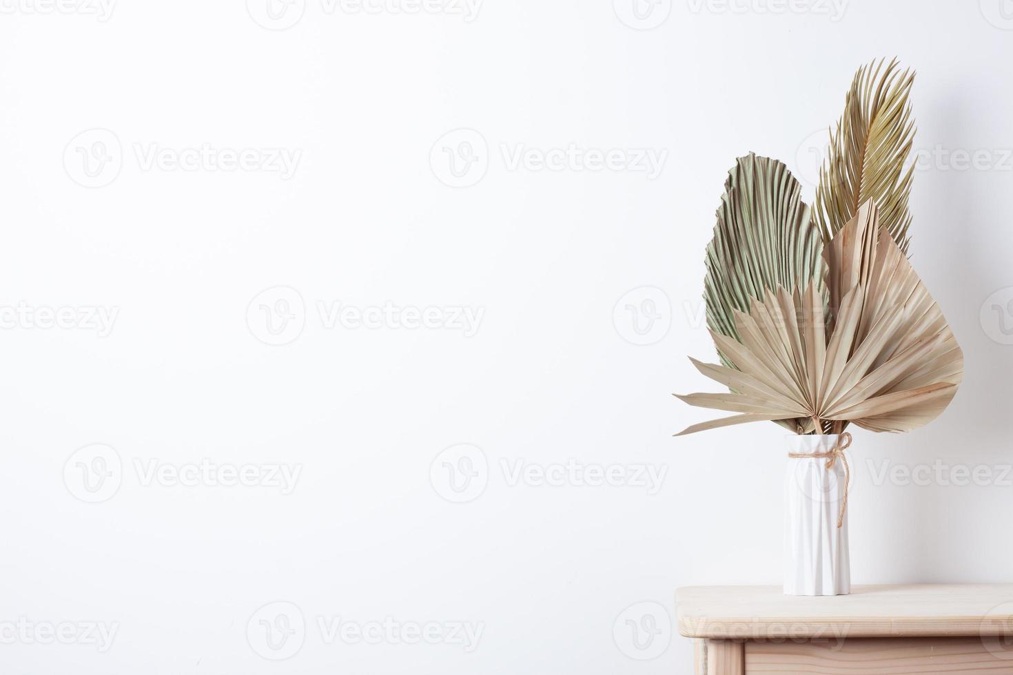 Home decoration with palm leaf on table. Close up, copy space photo