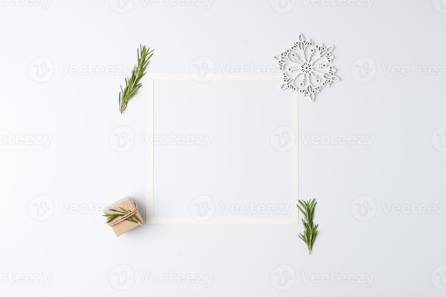 Christmas white minimal background with white frame and gift. Zero waste Christmas holiday concept. Flat lay, copy space photo