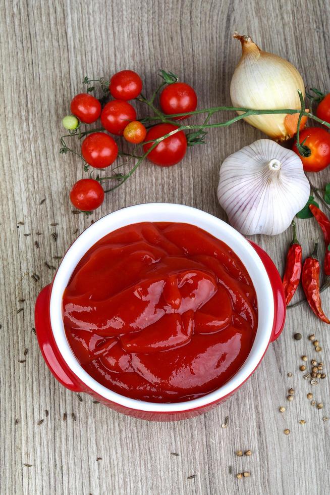 Tomato ketchup on wood photo