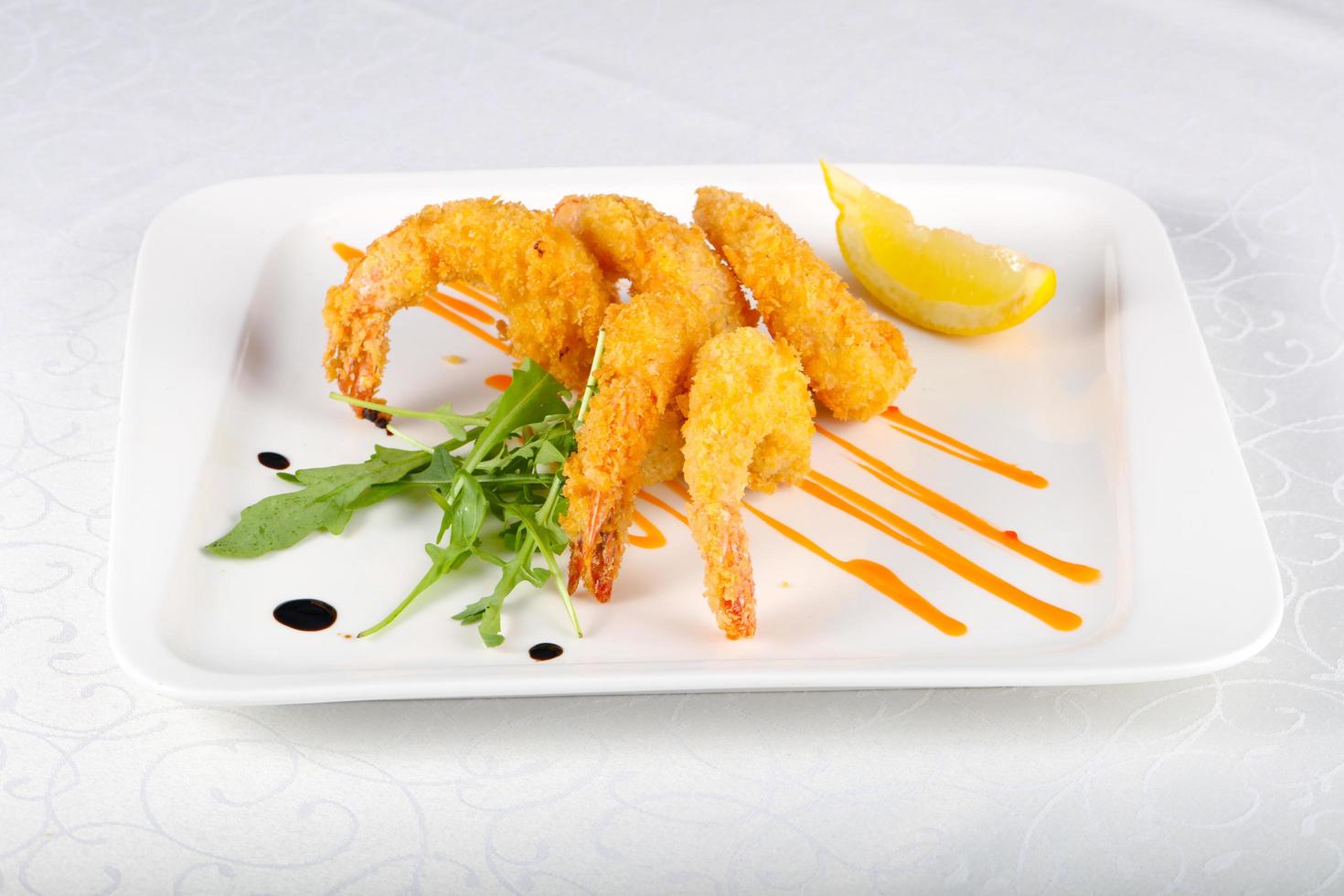 Crispy prawns on the plate and white background photo