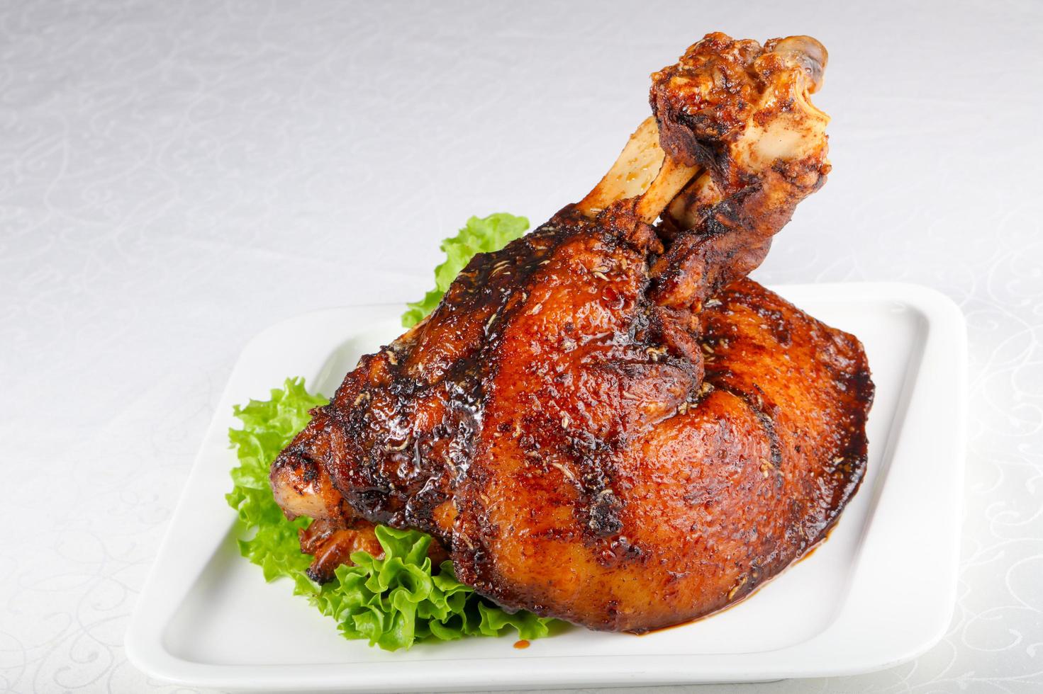 Pork leg on the plate and white background photo