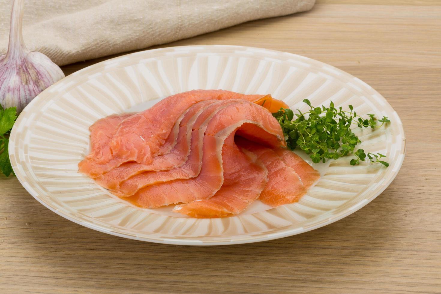 Sliced salmon on wood photo