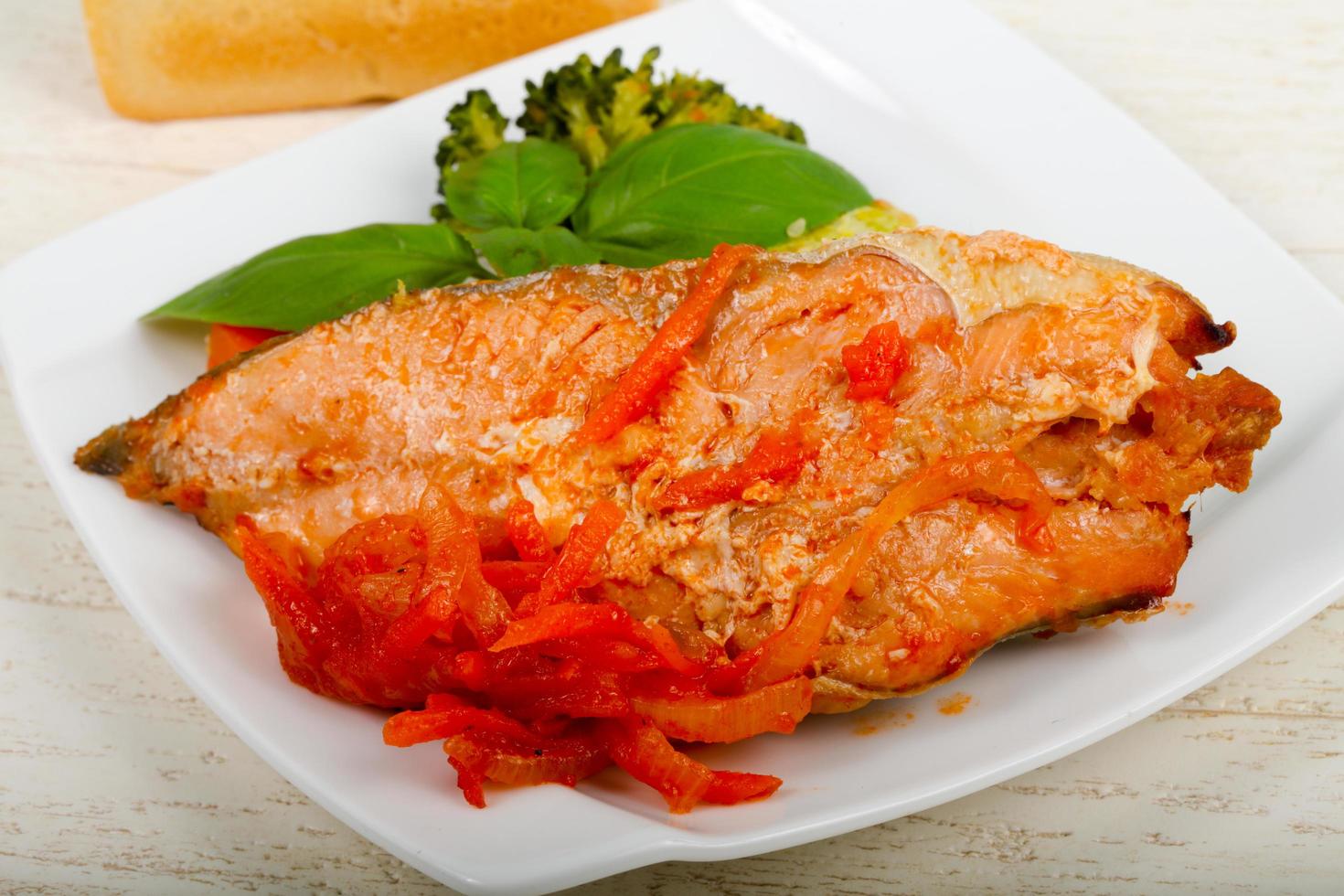 Baked Salmon on the plate and wooden background photo