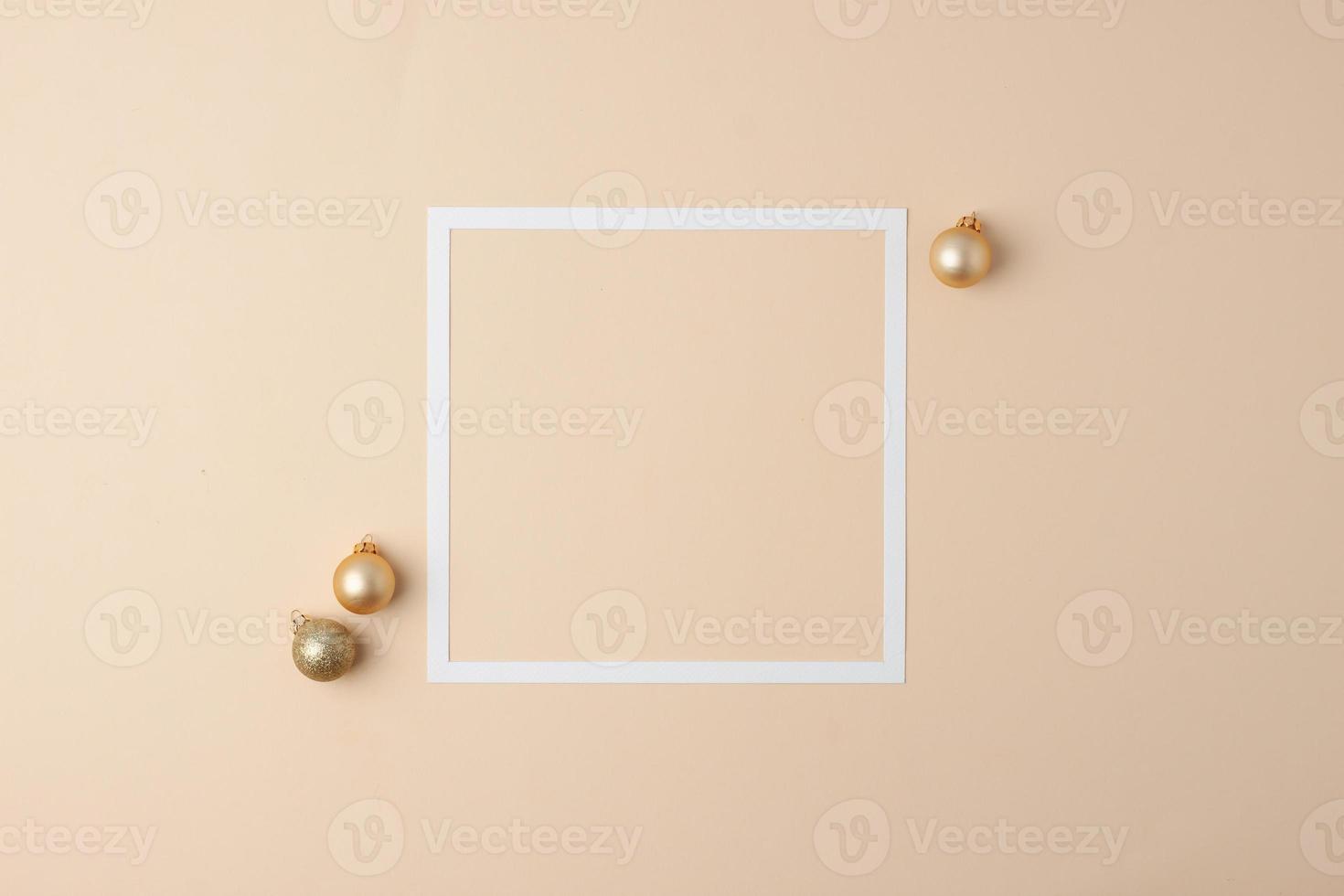 Christmas beige minimal background with white frame and beige ball. Flat lay, copy space photo