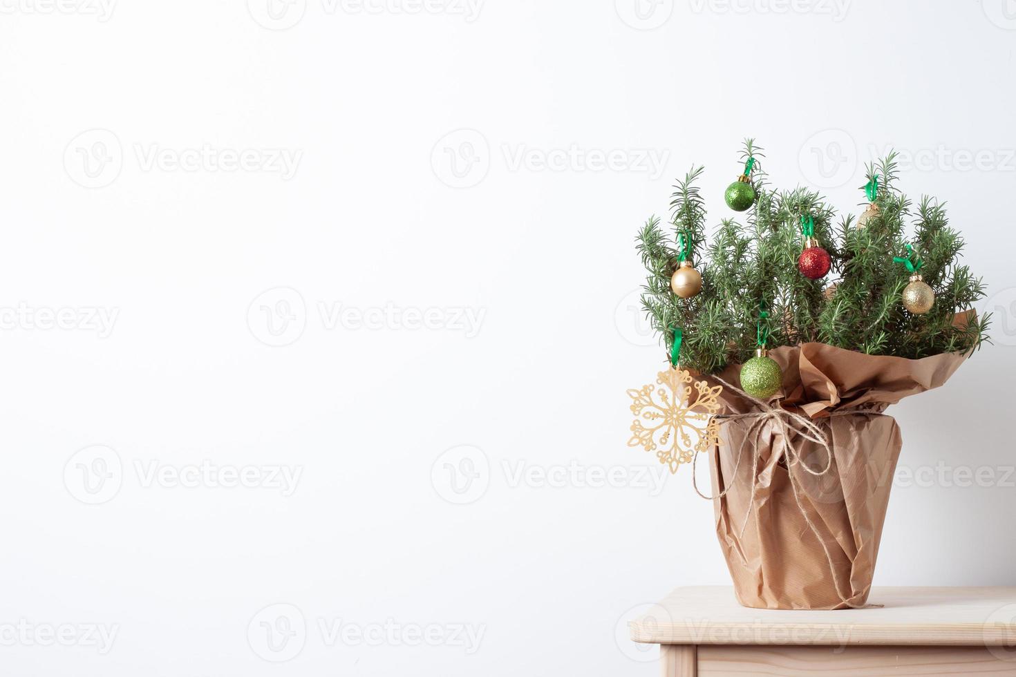 Zero waste Christmas natural decoration with rosemary as alternative Christmas tree on white background. Close up, copy space photo