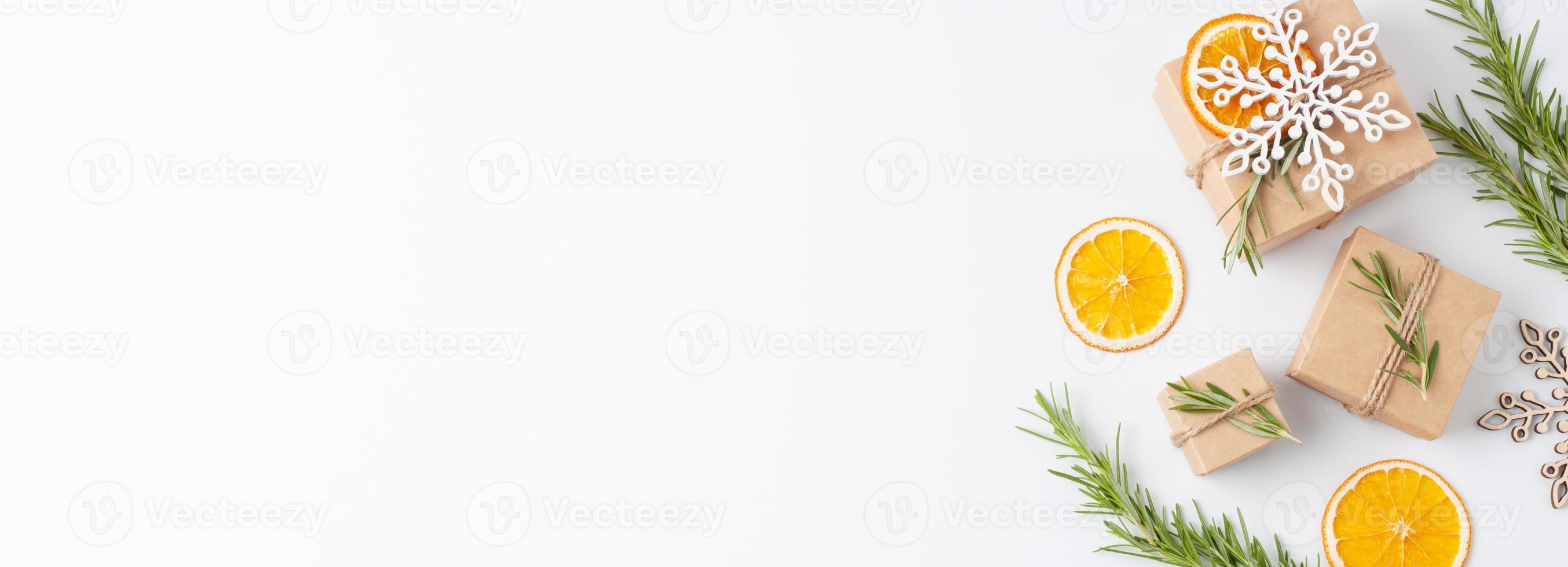 Eco friendly gifts in craft paper with rosemary on white background. Zero waste Christmas holiday concept. Flat lay, copy space photo