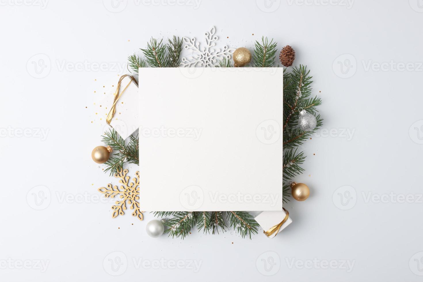 Christmas decorations with mock up greetings card and gifts on white background. Flat lay, copy space photo