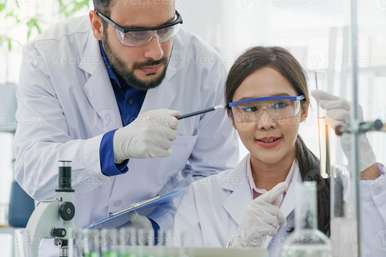 man-woman scientist with expertise in laboratory research biology discovery test tube analyzing extract biotechnology examining. Doctor student learning medical pharmacy chemist lab scientific. photo