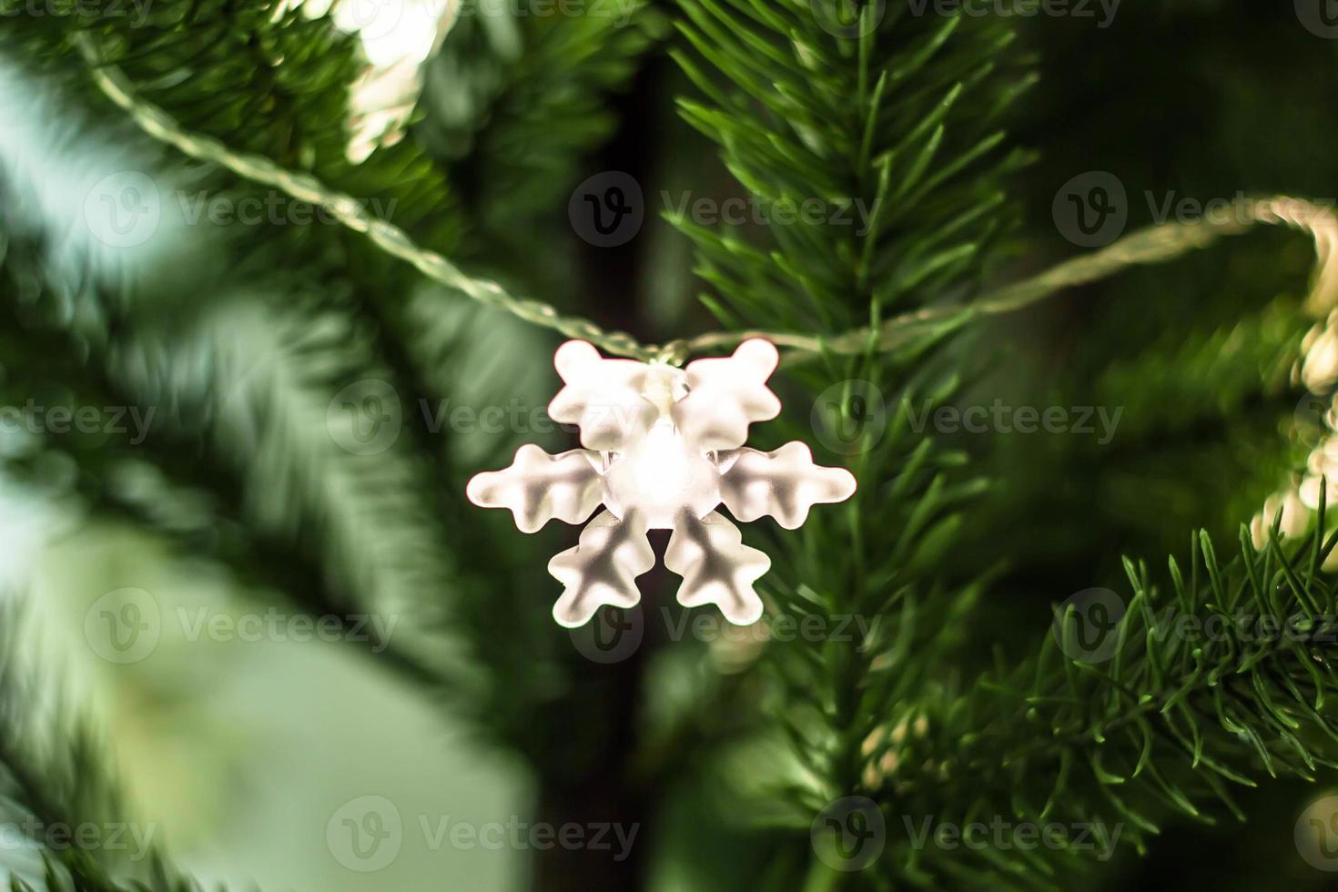 Christmas tree decorated a garland with snowflake lights photo