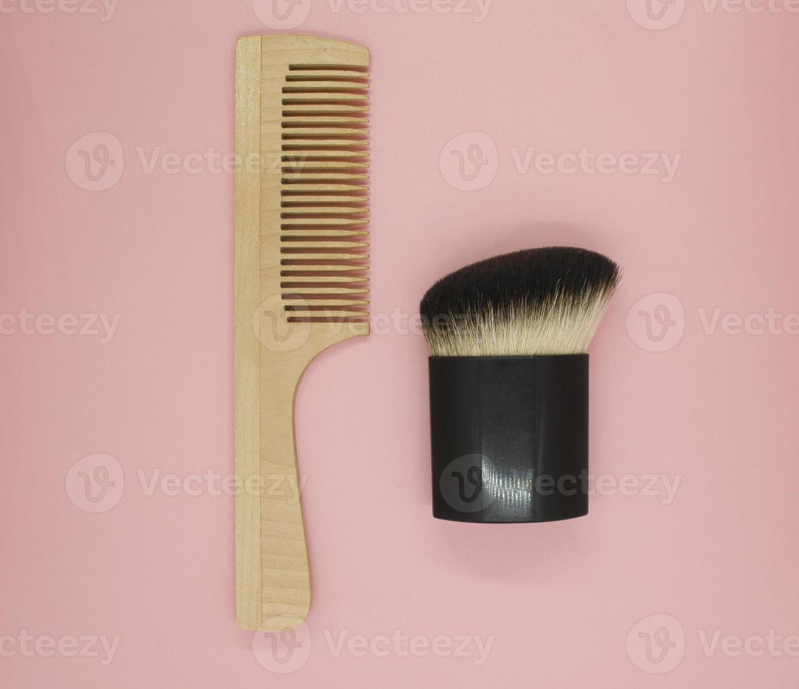 Wooden comb and cosmetic brush photo