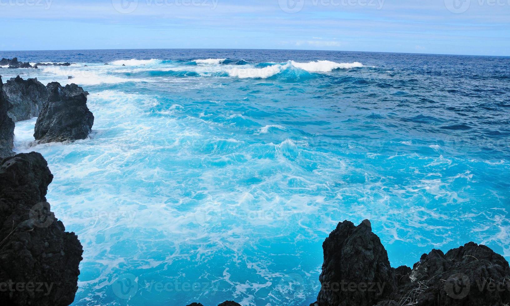 Blue water on Rocks photo