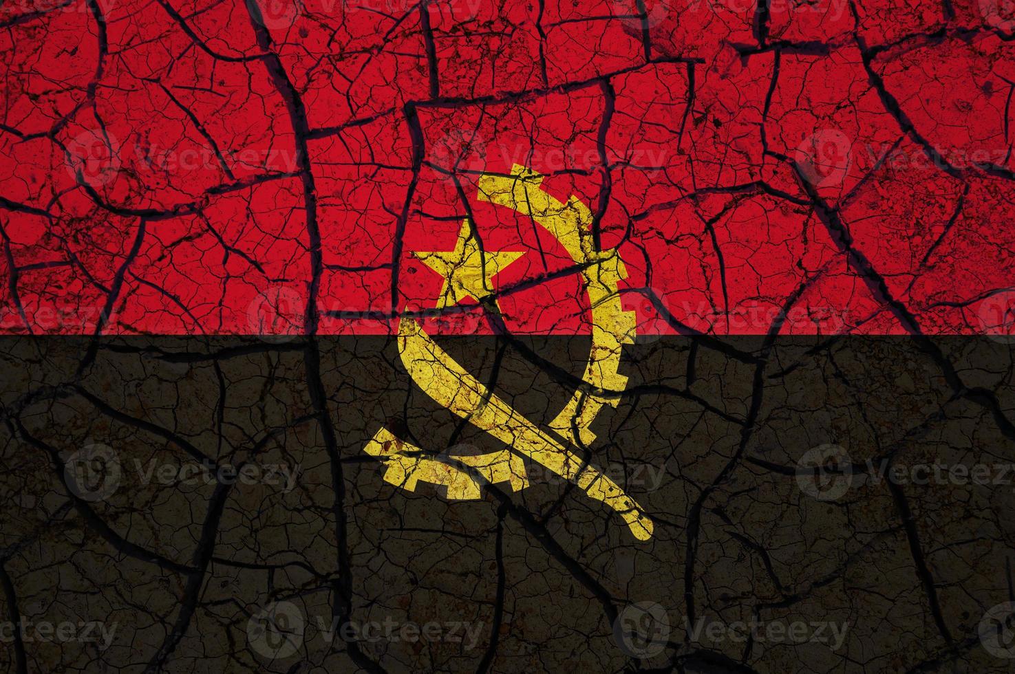 Dry soil pattern on the flag of Angola. Country with drought concept. Water problem. Dry cracked earth country. photo