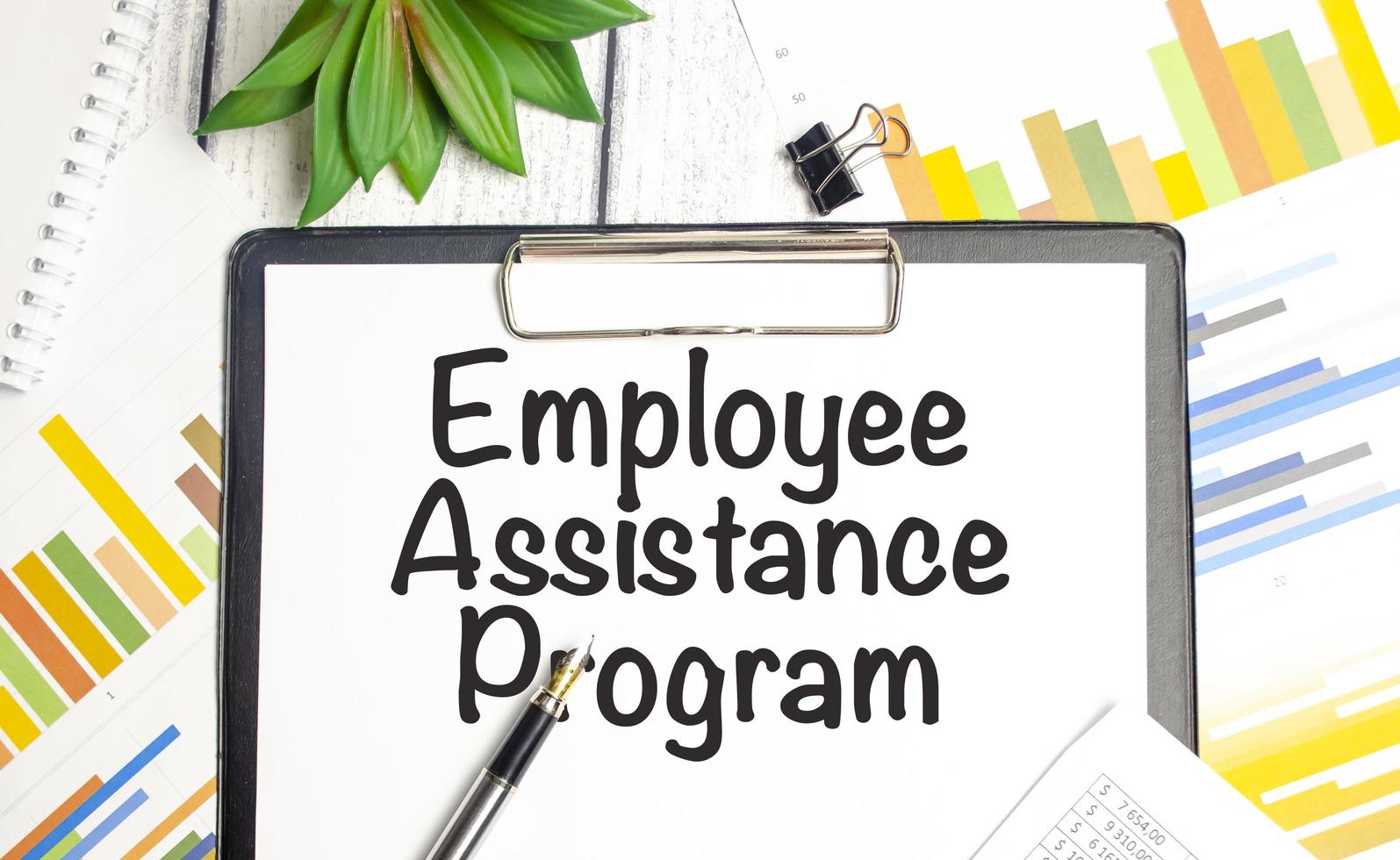 On a light background - light blue diagrams, paper clips and a sheet of ...