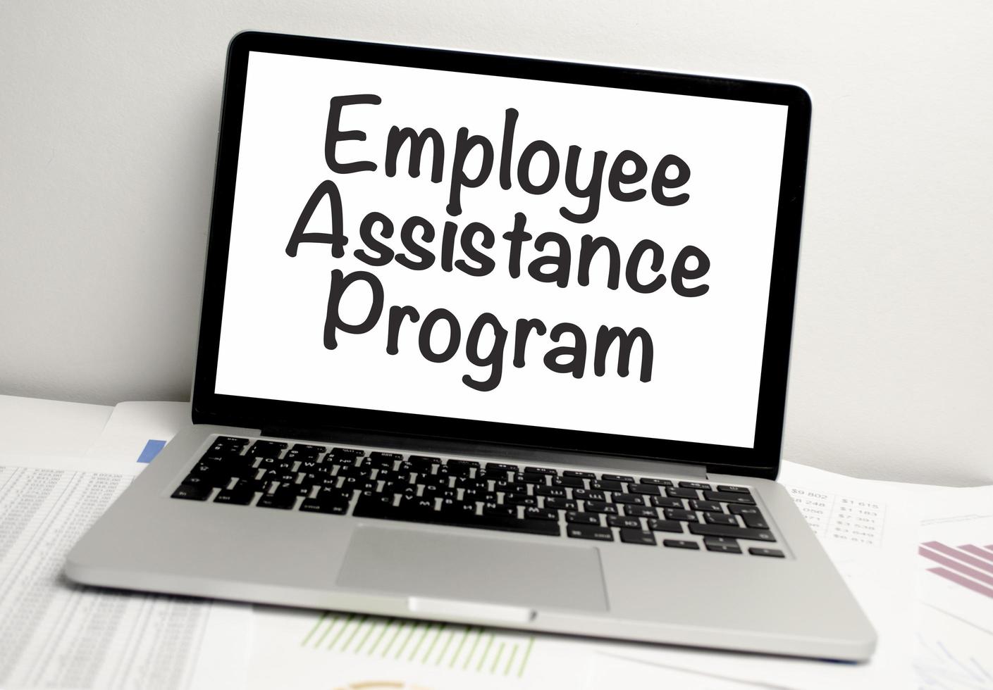EAP Employee Assistance Program text and notepad with pen, charts and calculator photo