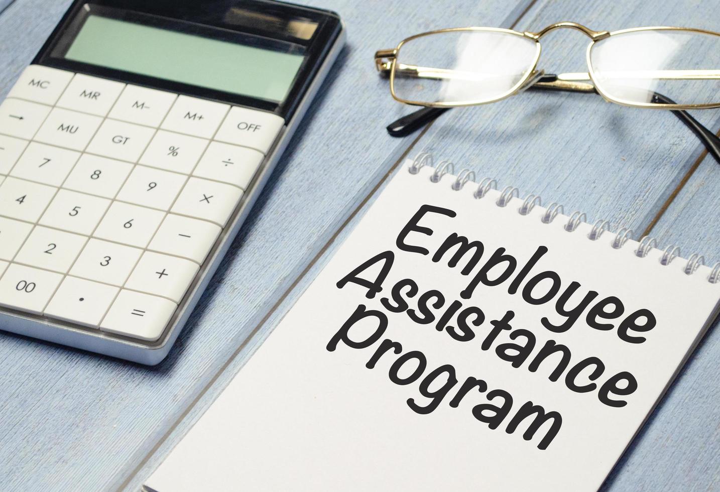 sheet of paper with the text EAP Employee Assistance Program and calculator photo