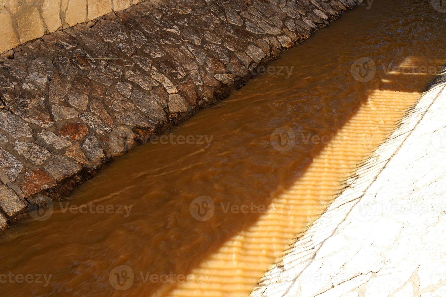 Altas orillas de hormigón de un río tormentoso. foto