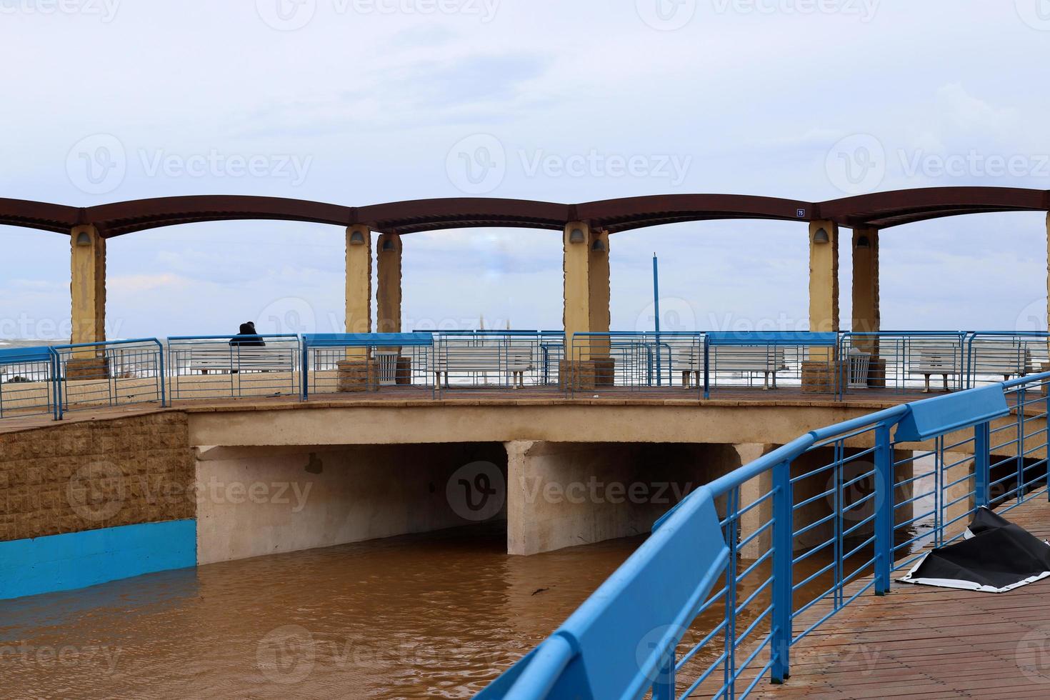 High concrete banks of a stormy river. photo