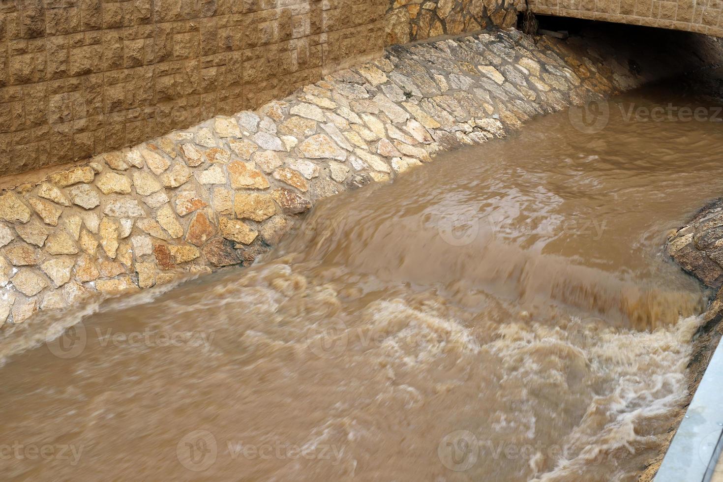 High concrete banks of a stormy river. photo