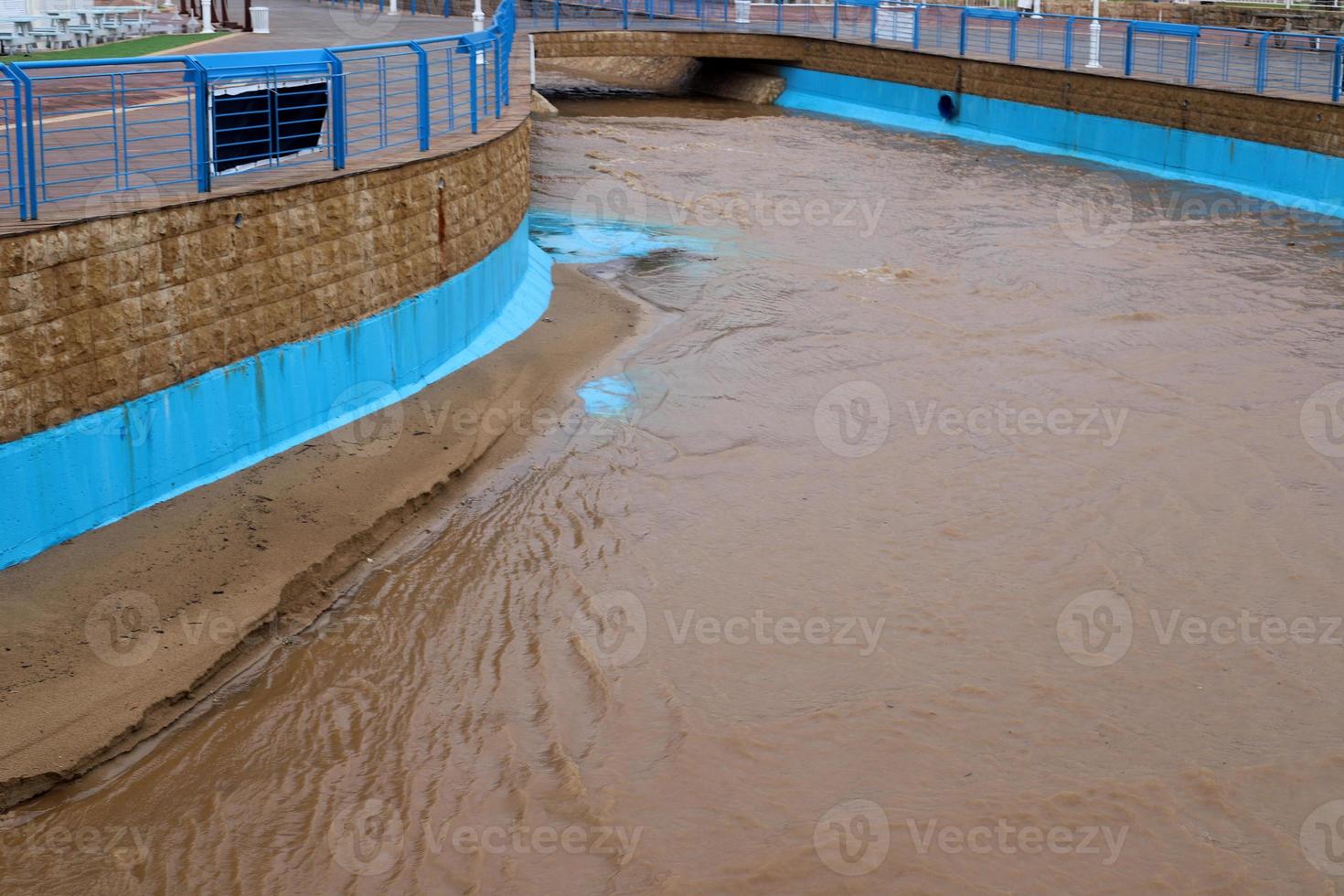 High concrete banks of a stormy river. photo