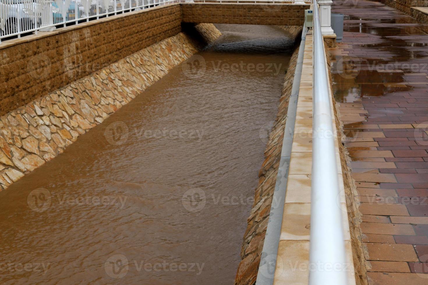 High concrete banks of a stormy river. photo
