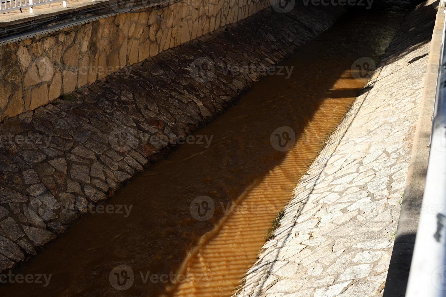 High concrete banks of a stormy river. photo