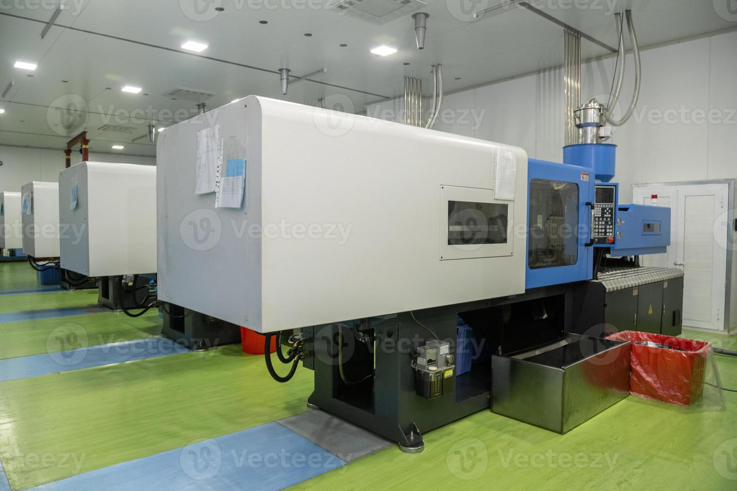 A molding machine in a factory for the production of medical syringes and droppers photo