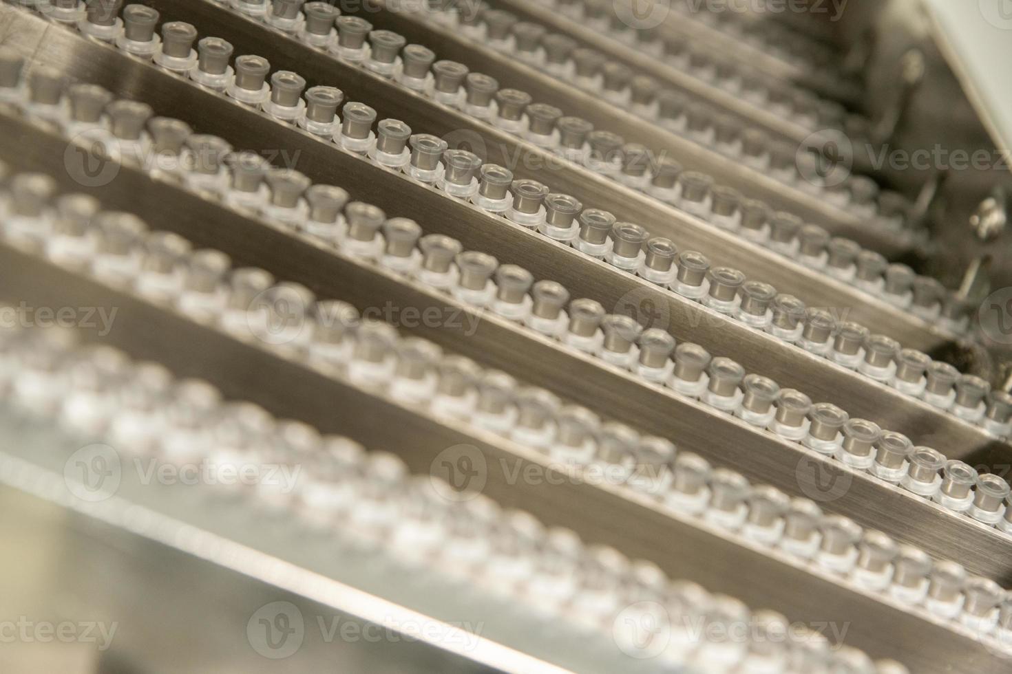 A closeup of the production of medical needles for syringes photo