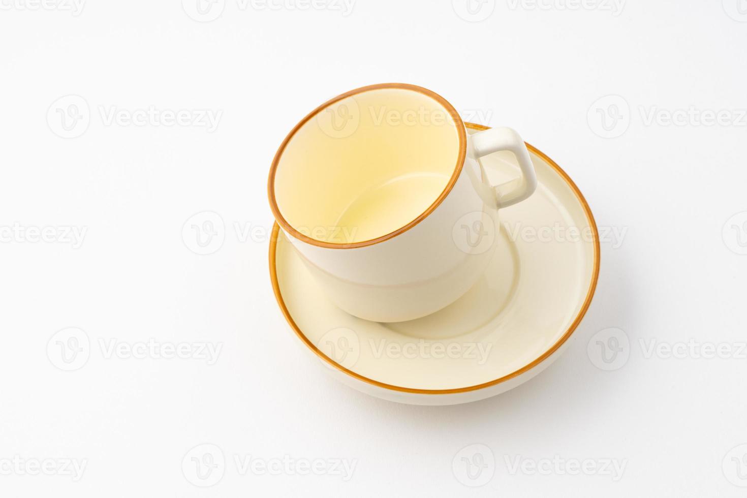 A set of white and brown ceramic plate and cup on a white background photo