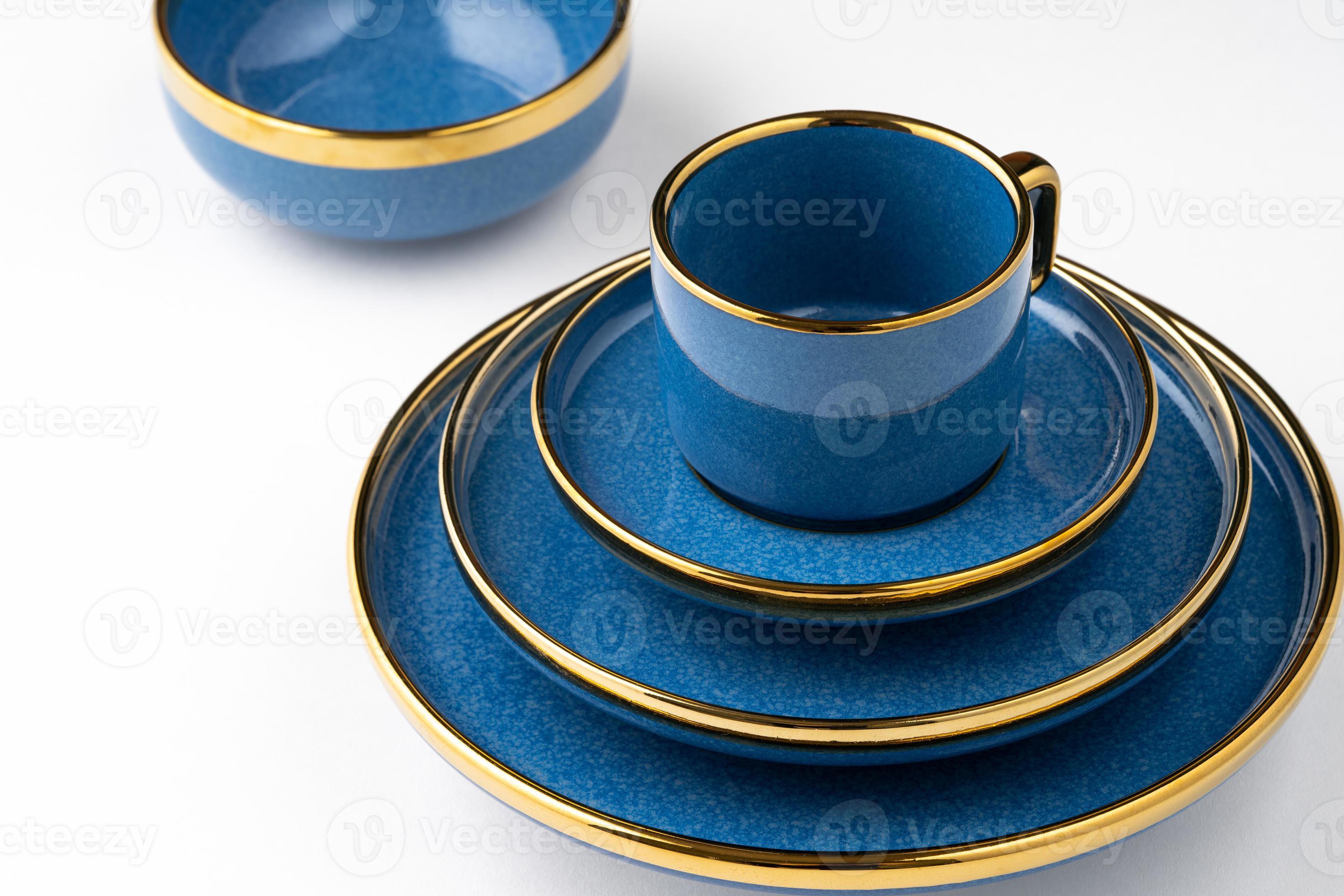 A set of blue ceramic plates and cup on a white background 12851767