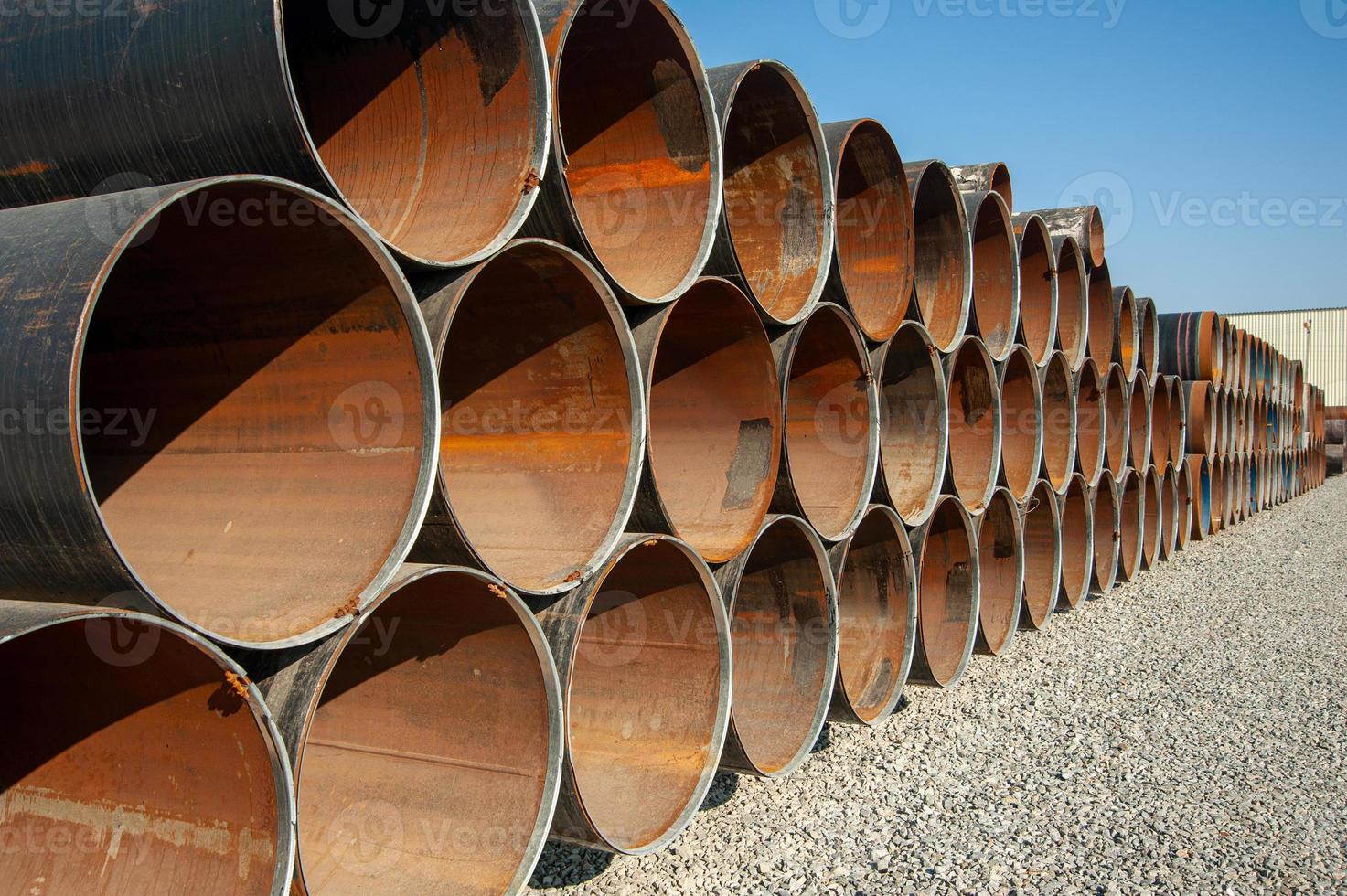 A line of oilfield large streel pipes in industrial construction area photo