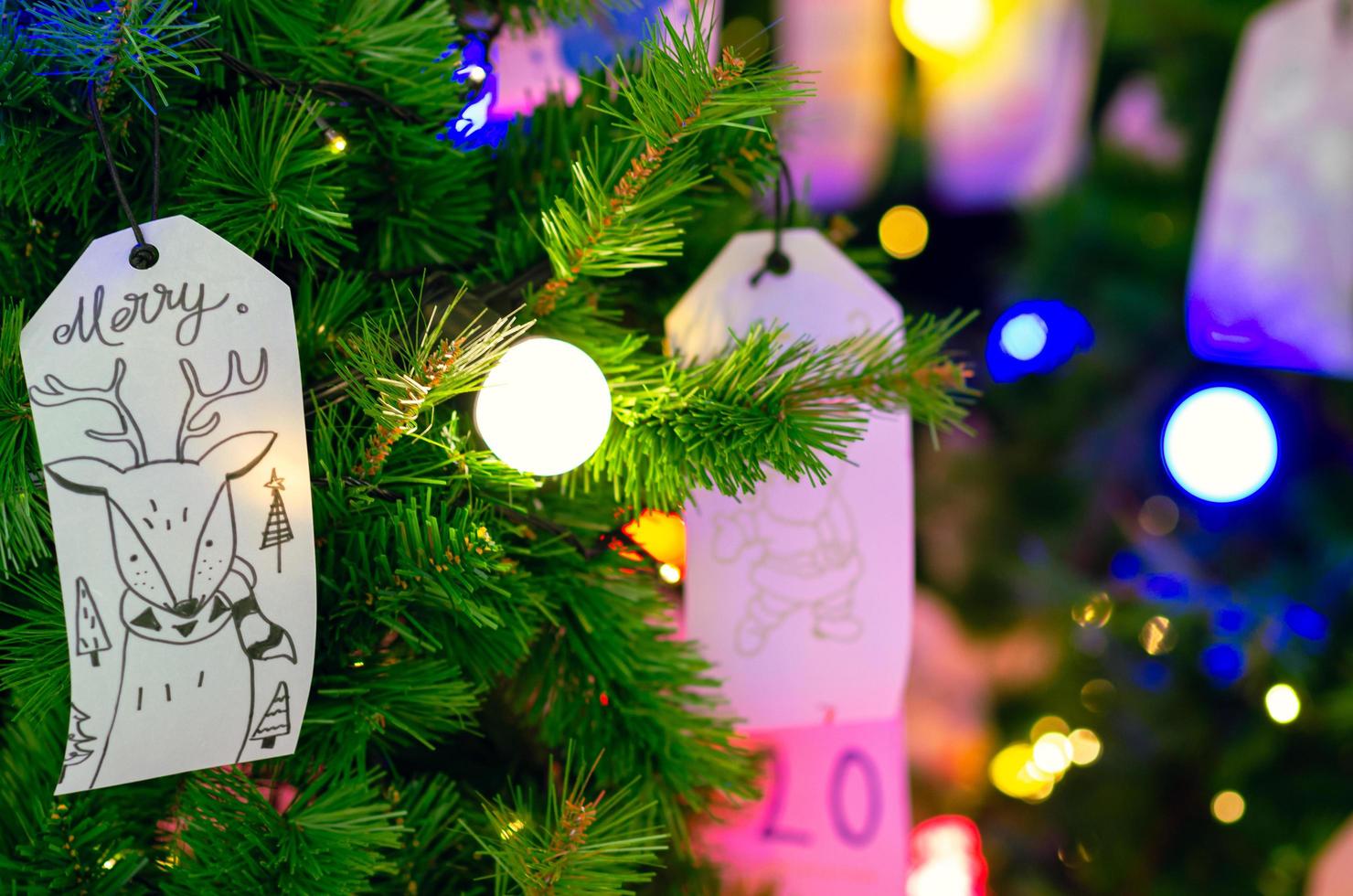 Paper Hanging On Christmas Tree For Holiday Decoration With Colorful paper-hanging-on-christmas-tree-for-holiday-decoration-with-colorful