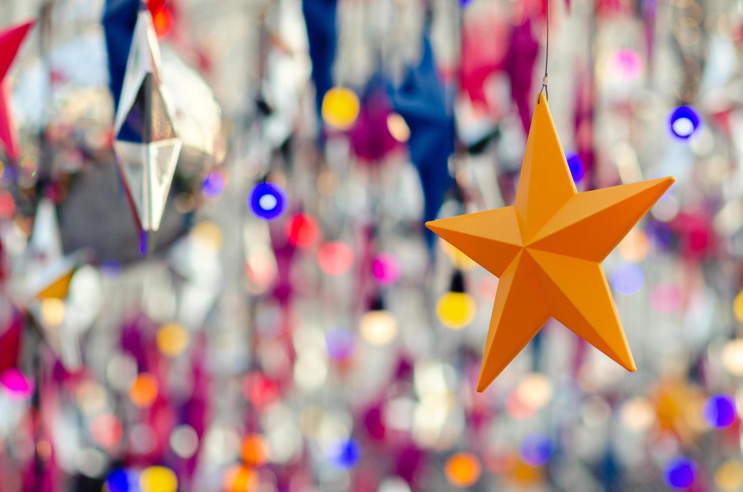 Colorful star ornaments hanging to decorate for Christmas holiday. photo