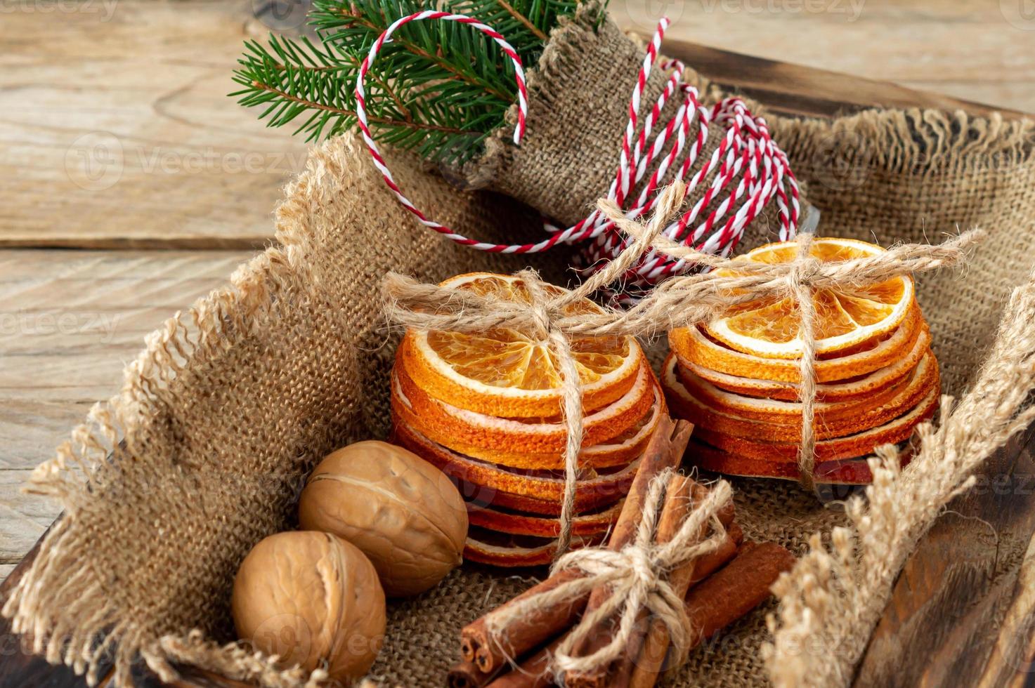 Rustic christmas composition with dried oranges, cinnamon sticks and fir tree branches in a wooden box photo