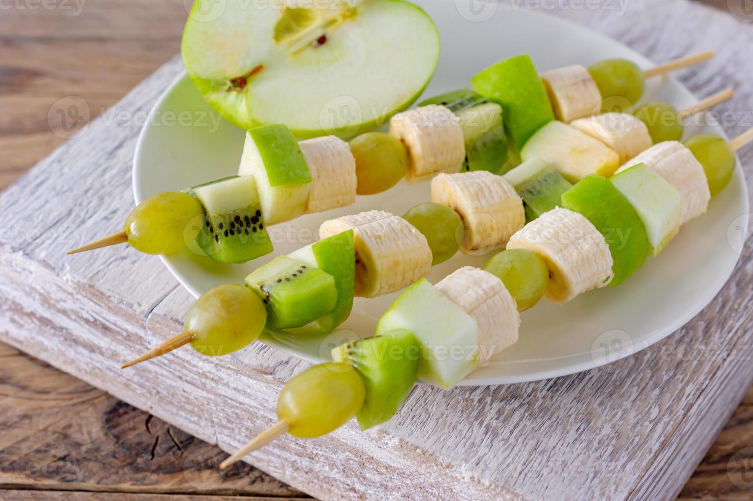 Festive food. Canape with fruits on a plate. photo