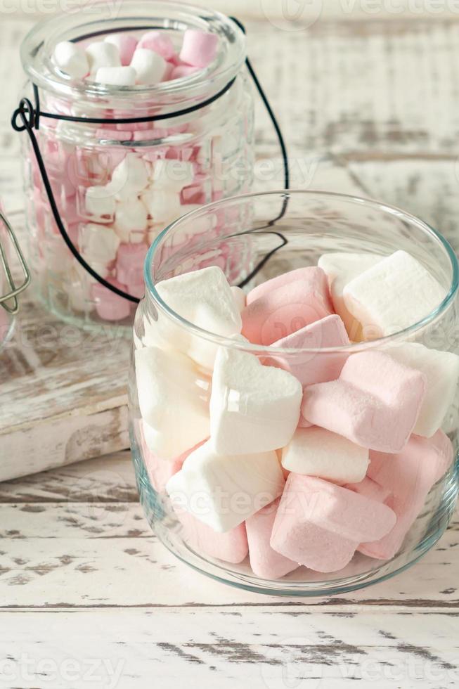 White and pink marshmallows for roasting and hot chocolate in a bowls, close up. Winter food background concept. photo