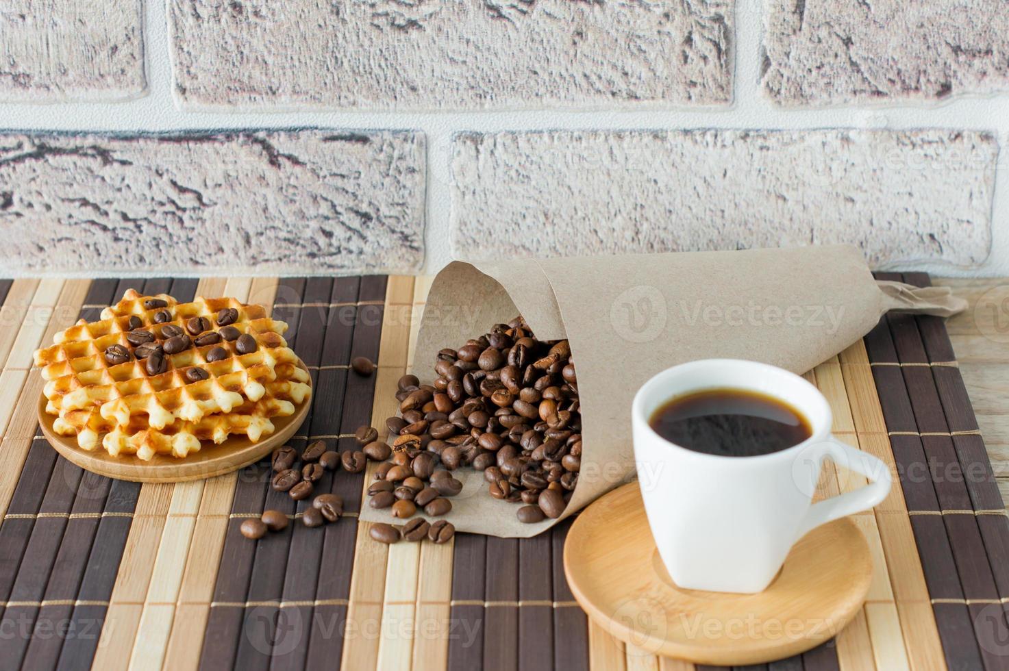 Two cups of freshly brewed espresso on wooden table. coffee beans on light wooden table, rustic style, homemade. photo