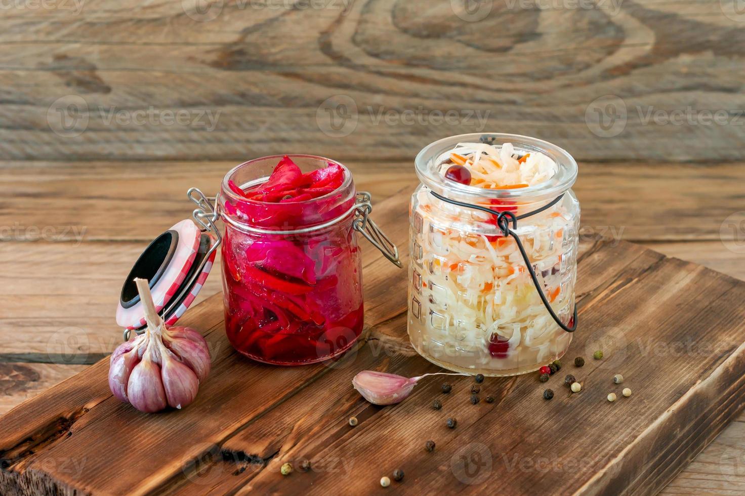 Sauerkraut variety preserving jars. Homemade Sauerkraut with Carrot and Salad Cabbage with Beetroot on a wooden table. Fermented food. photo
