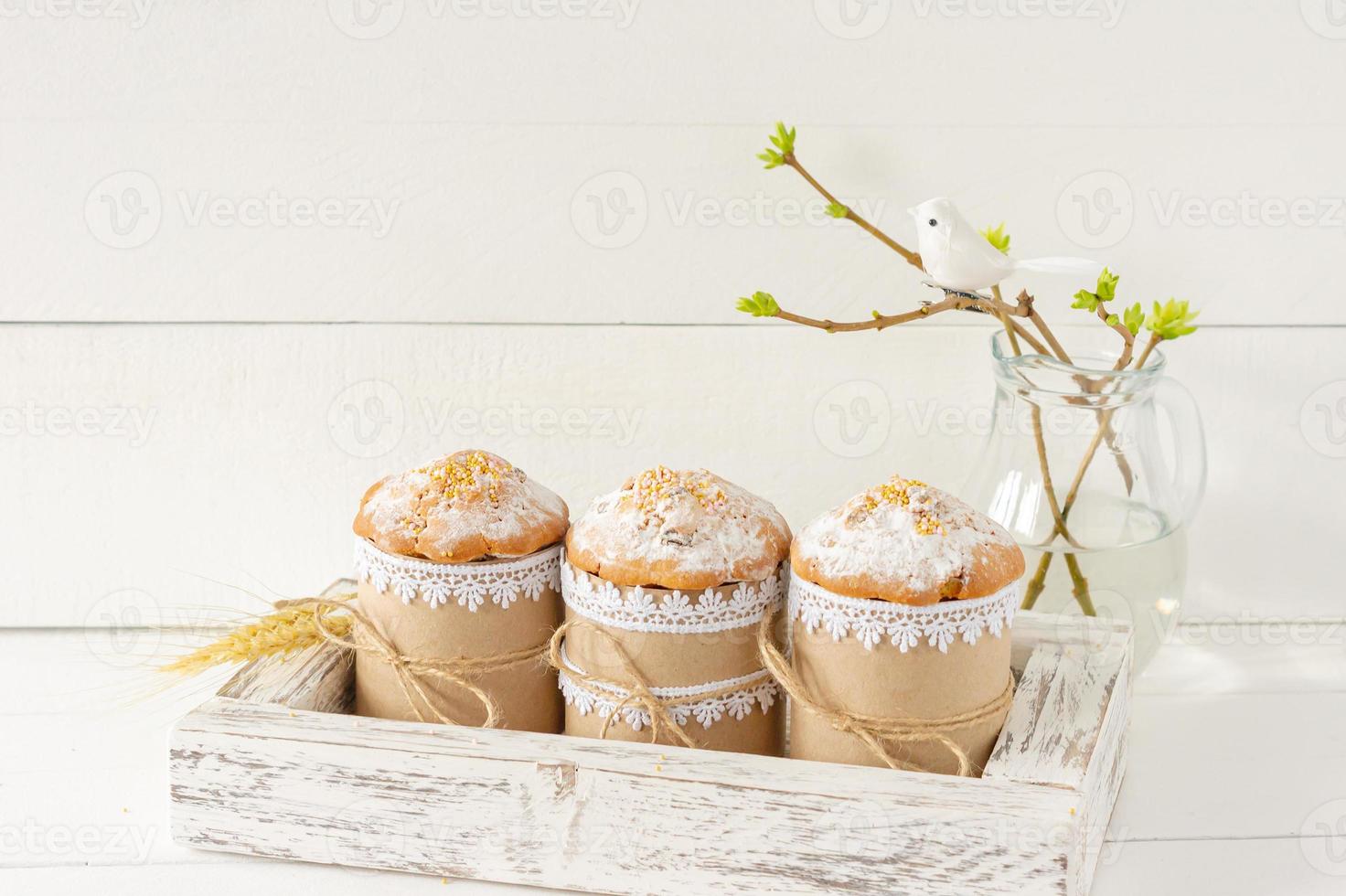 Arrangement decoration Happy Easter holiday background concept. Easter cakes in wooden box and spring twigs. Pastel colors. photo