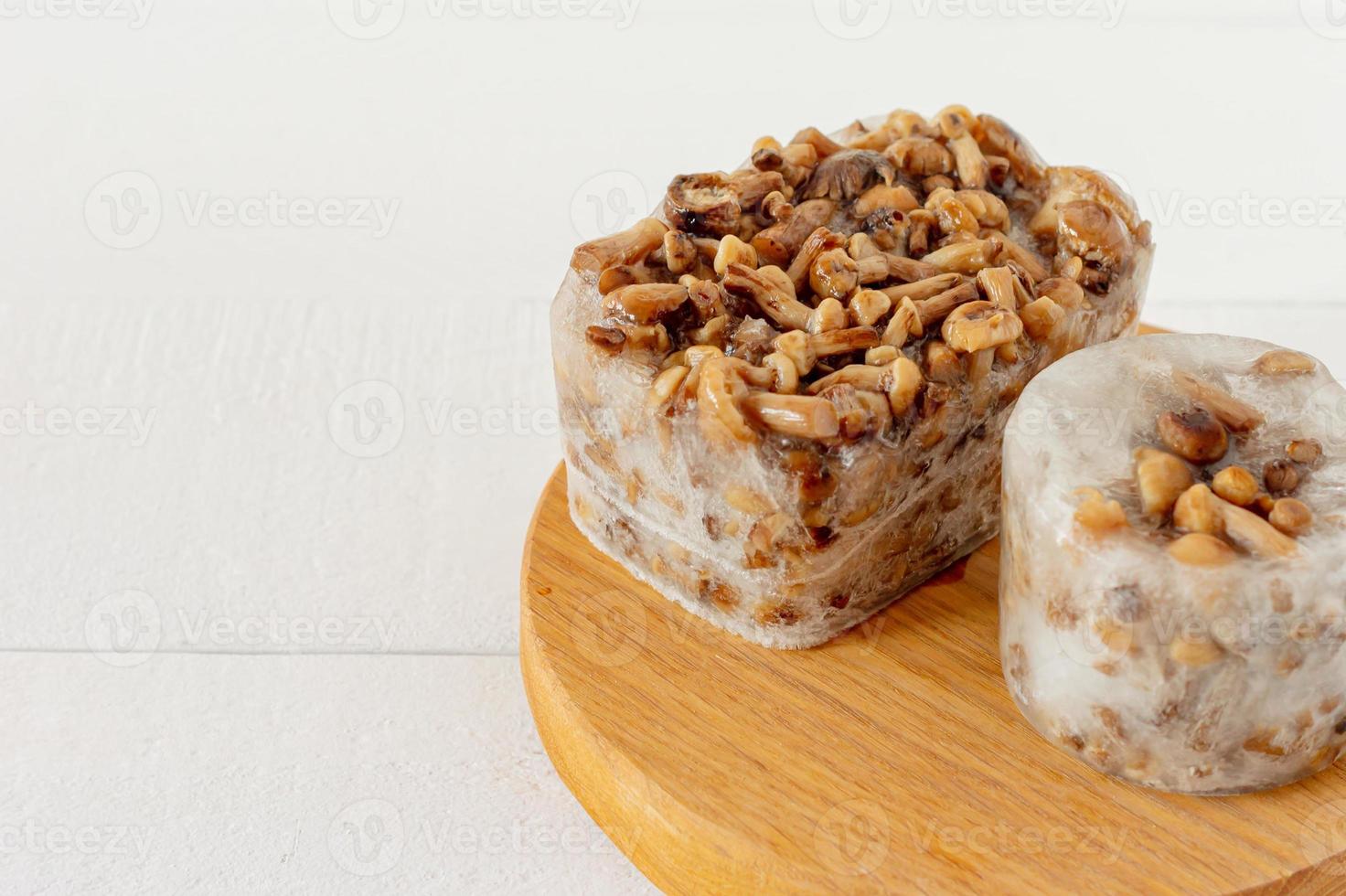 Semi-finished products. Frozen food. Agaric of honey mushrooms on cutting board. photo