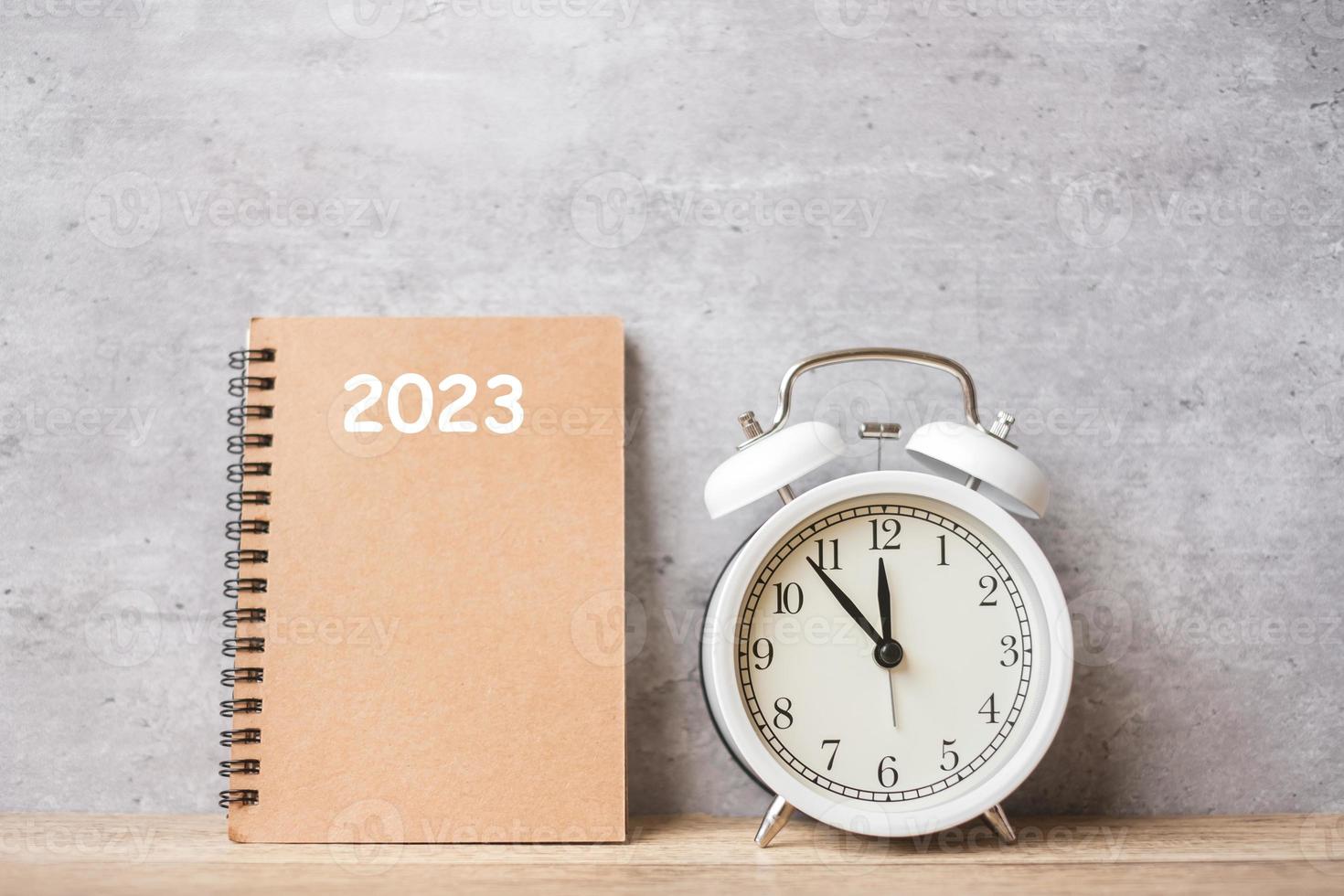 Happy New Year with vintage alarm clock and 2023 calendar. Christmas, New Start, Resolution, countdown, Goals, Plan, Action and Motivation Concept photo