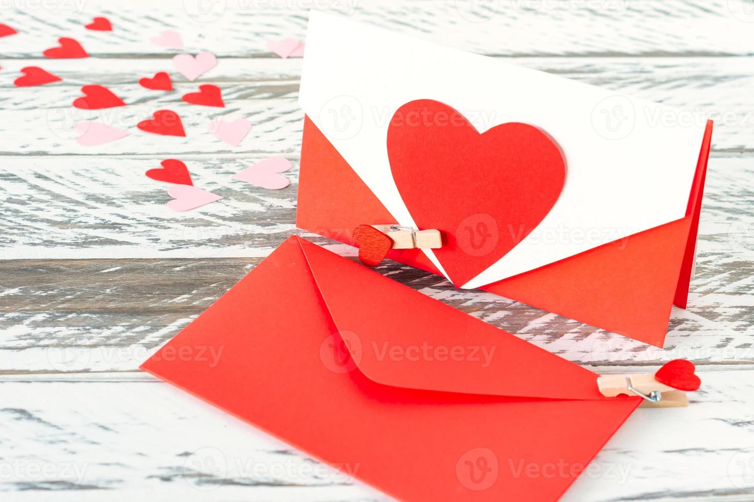 love letters with paper heart on wooden background. Festive greeting card for St Valentines day. photo