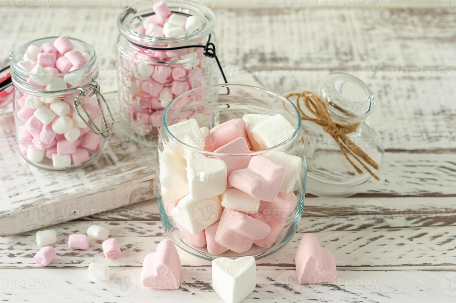 White and pink marshmallows for roasting and hot chocolate in a bowls, close up. Winter food background concept. photo