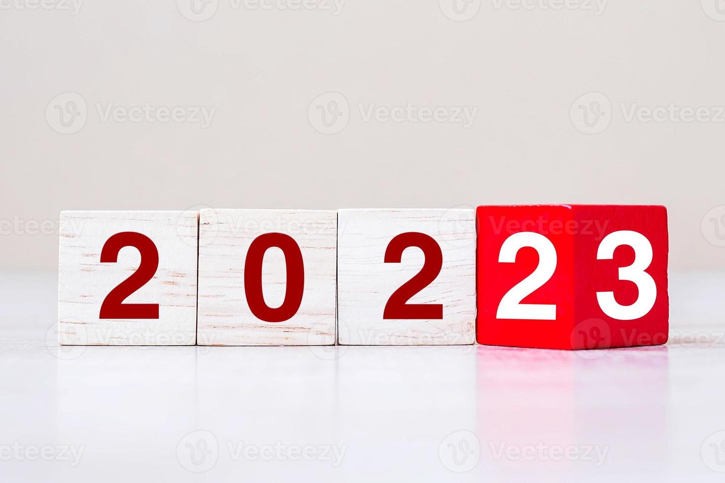 flipping block 2022 to 2023 text on table. Resolution, strategy, plan, goal, motivation, reboot, business and New Year holiday concepts photo