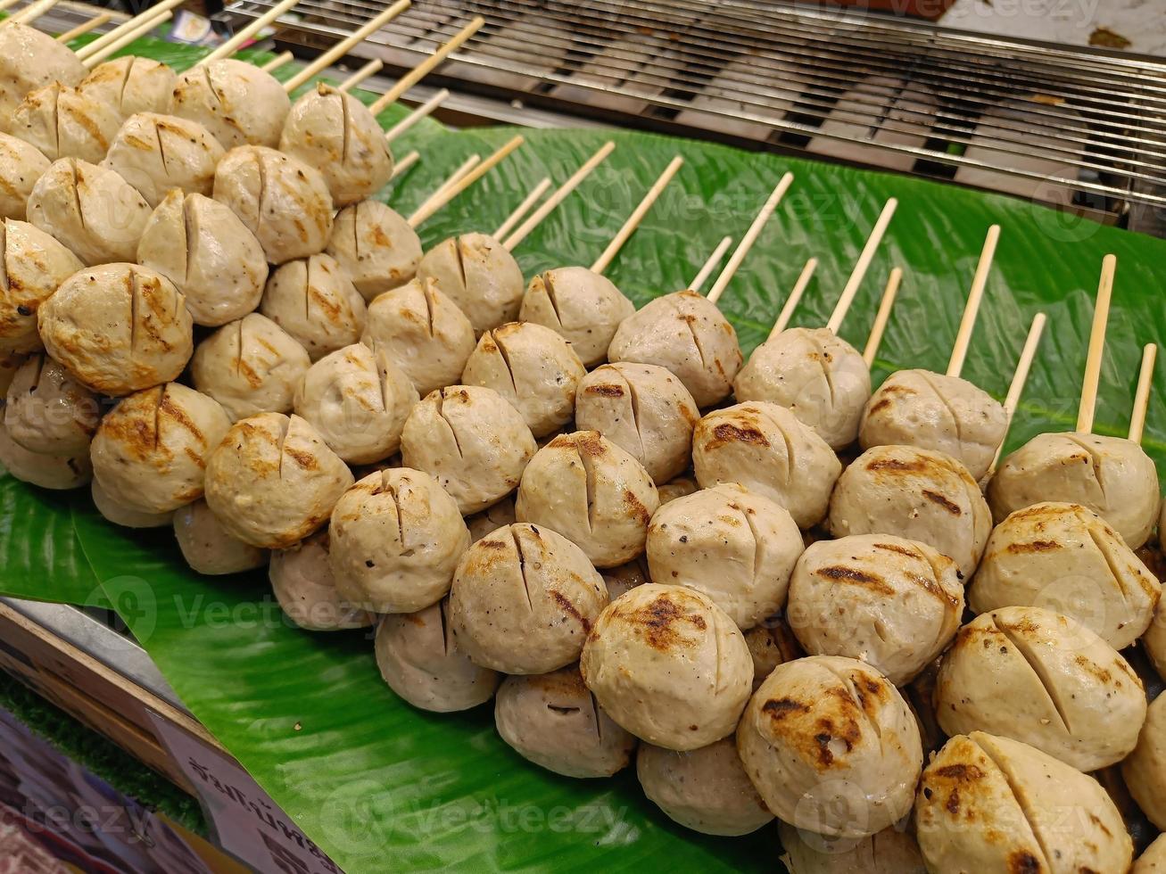 Big grilled pork meatballs sale at the market, Thai street food. Easy to find. photo