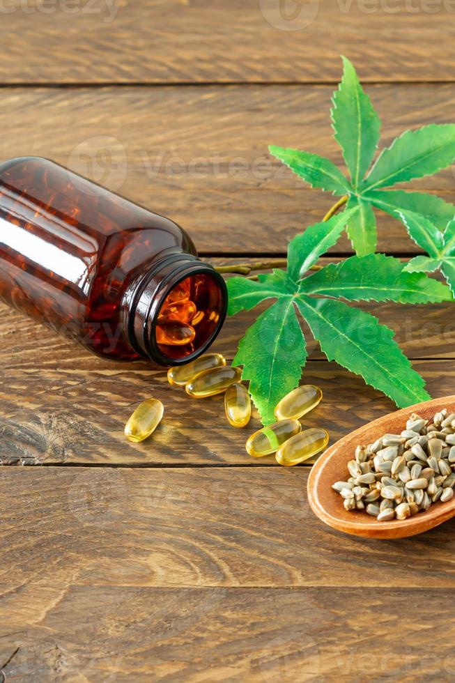 cannabis CBD oil hemp products - capsules and seeds of hemp photo