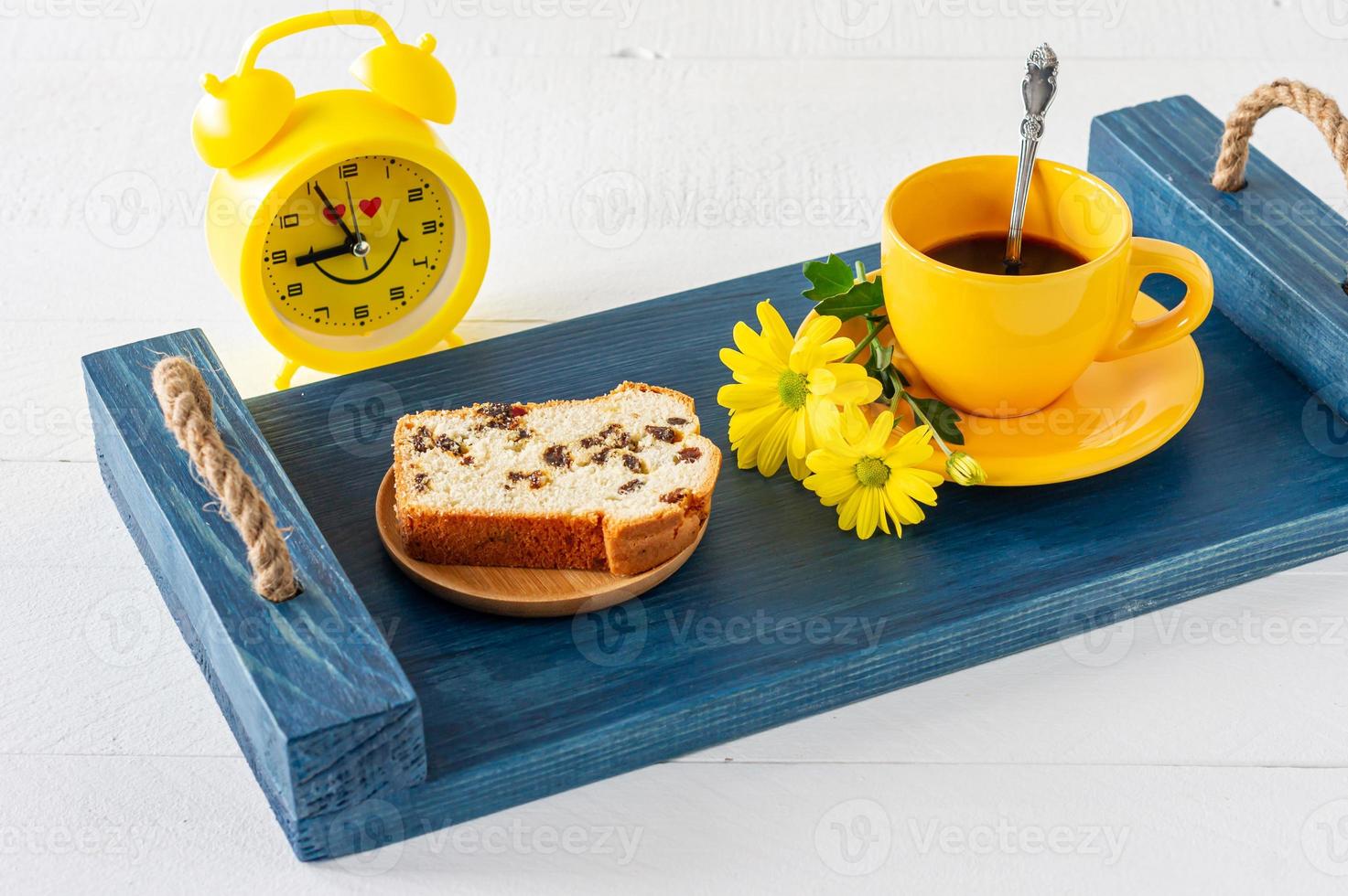 Slices of pound cake with raisins and a cup of coffee served on a tray. Morning tasty breakfast photo