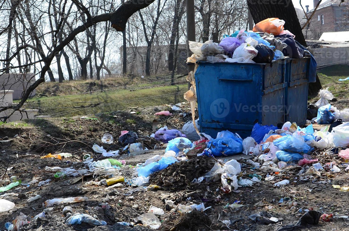 The garbage can is packed with garbage and waste. Untimely removal of garbage in populated areas photo