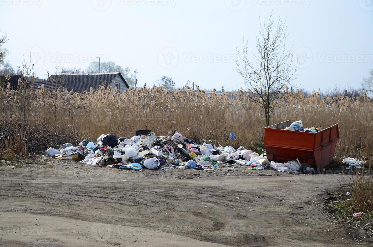 The garbage can is packed with garbage and waste. Untimely removal of garbage in populated areas photo